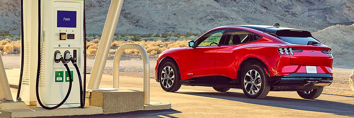 A 2021 Ford Mustang Mach E plugged into a Ford mobile charger