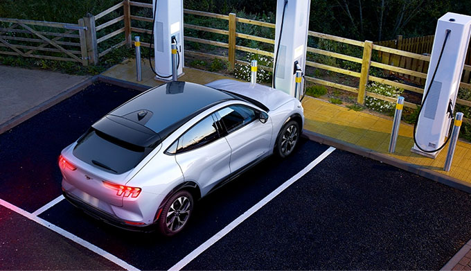 A 2021 Mustang Mach E parked at a charging station